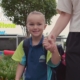 A Prep student holds her mum's hand walking to school