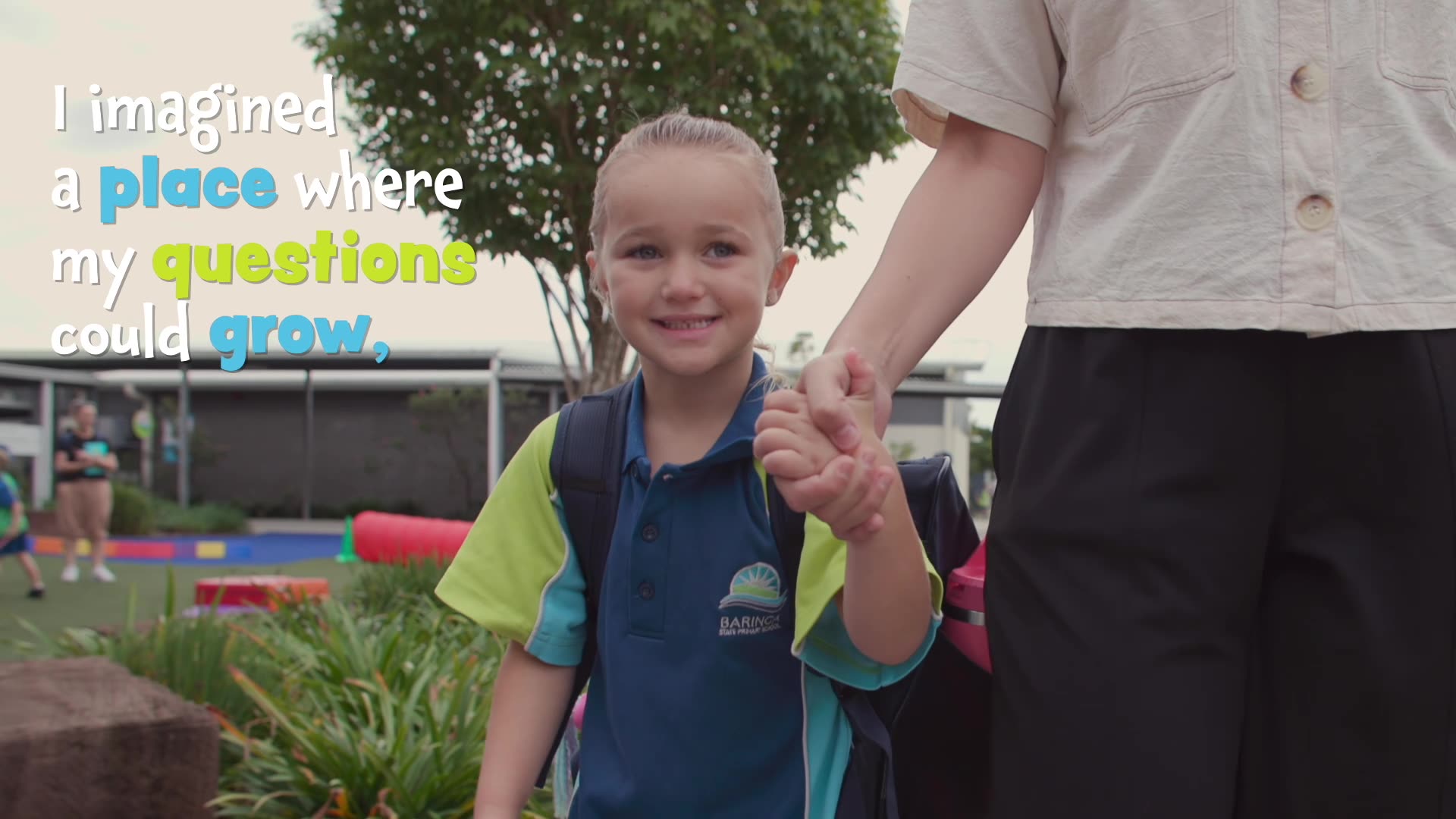 A Prep student holds her mum's hand walking to school